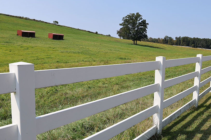 Hillside with white fence.